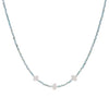 Necklace with small star-shaped pendants on a light blue beaded chain against a white background