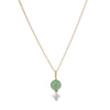 Necklace with a green bead and white pendant on a gold chain against a white background