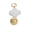Jewelry charm with white flower bead and gold ball on a white background