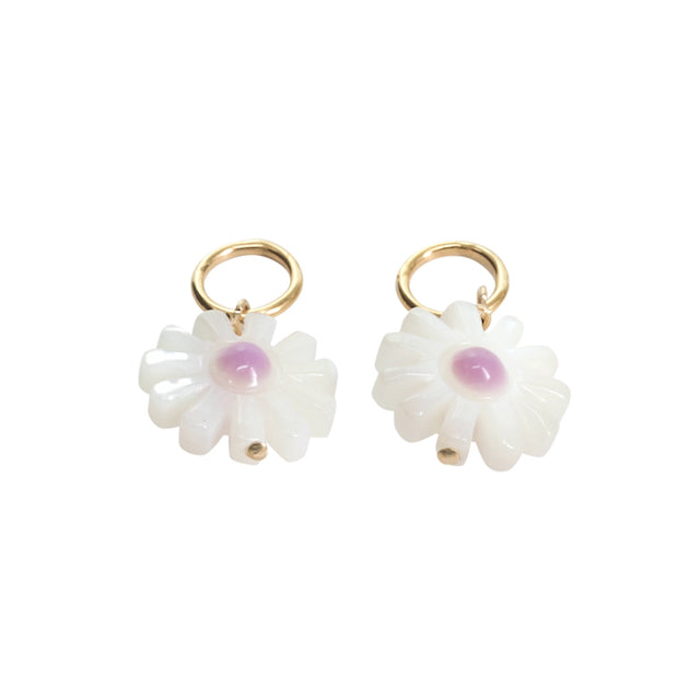 Pair of white flower-shaped earrings with gold hooks on a white background
