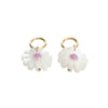 Pair of white flower-shaped earrings with gold hooks on a white background