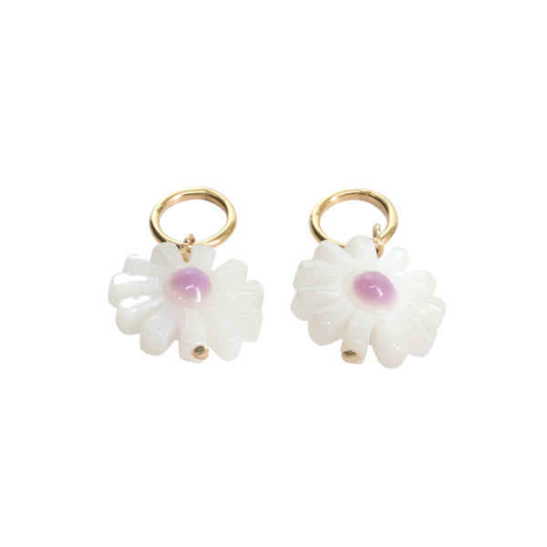 Pair of white flower-shaped earrings with gold hooks on a white background