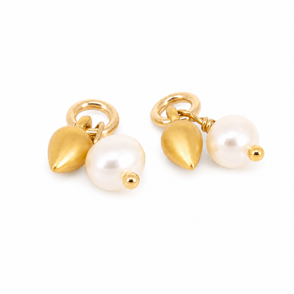 Pair of gold earrings with pearl drops on a white background