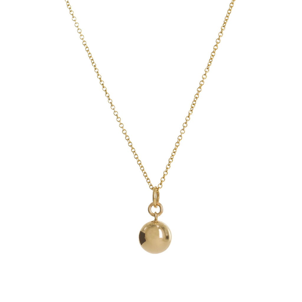 Gold necklace with a round pendant on a white background