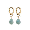 Gold hoop earrings with teal stone drops on a white background