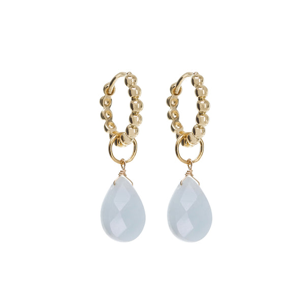 Gold hoop earrings with teardrop-shaped gemstones on a white background