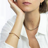 Woman wearing a necklace and bracelet on a white background