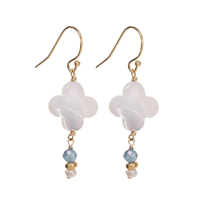 Pair of earrings with white floral beads and gold accents on a white background
