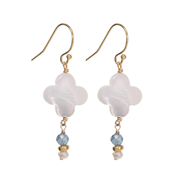 Pair of earrings with white floral beads and gold accents on a white background