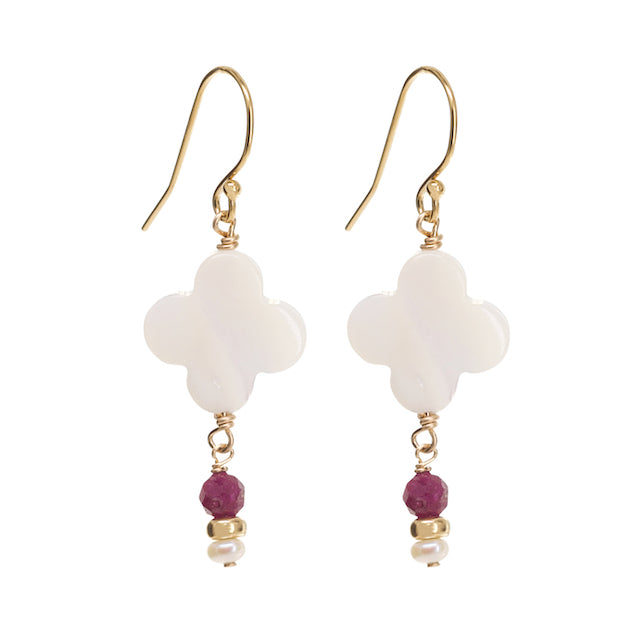 Pair of earrings with white floral designs and gold and ruby beads on a white background