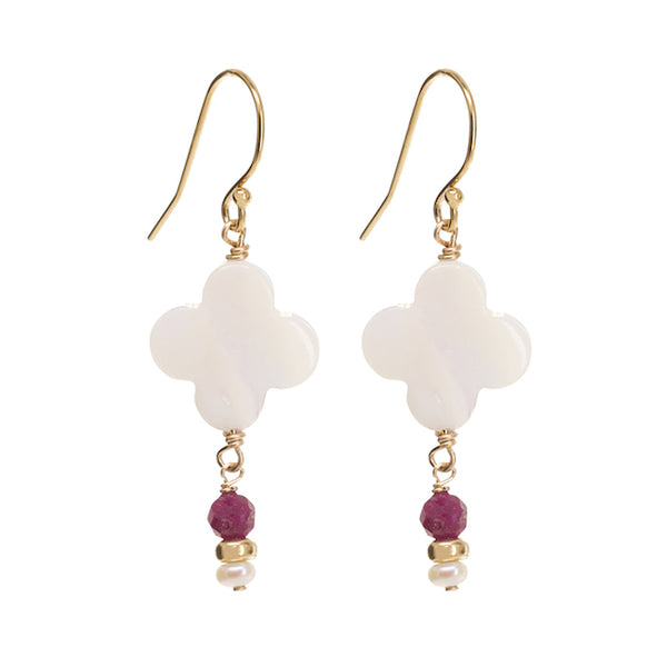Pair of earrings with white floral designs and gold and ruby beads on a white background