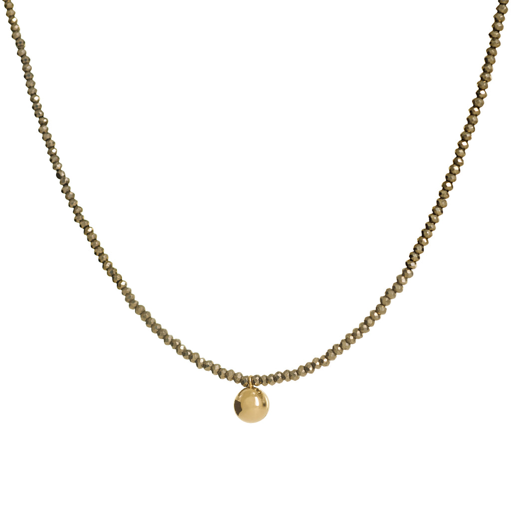 Gold beaded necklace with a round pendant on a white background