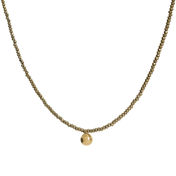 Gold beaded necklace with a round pendant on a white background